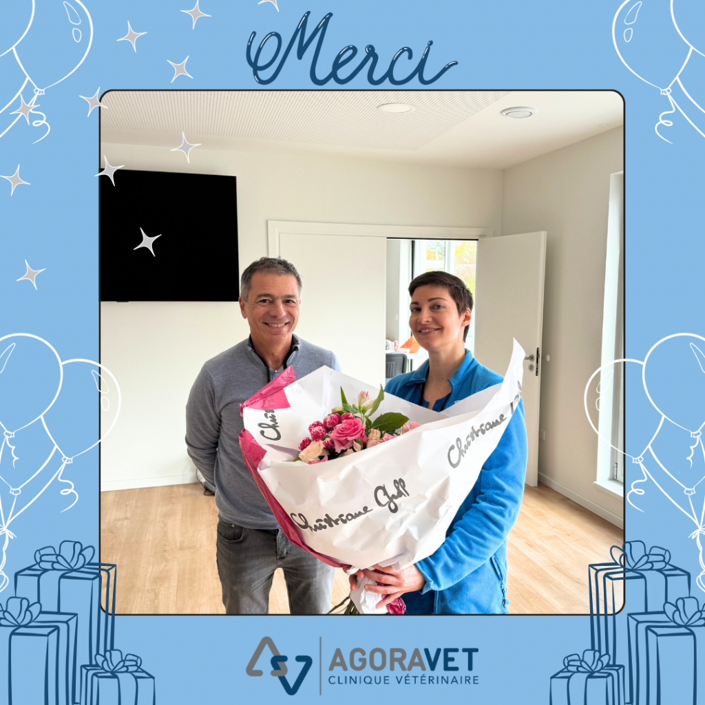 Two smiling people with a bouquet of flowers.